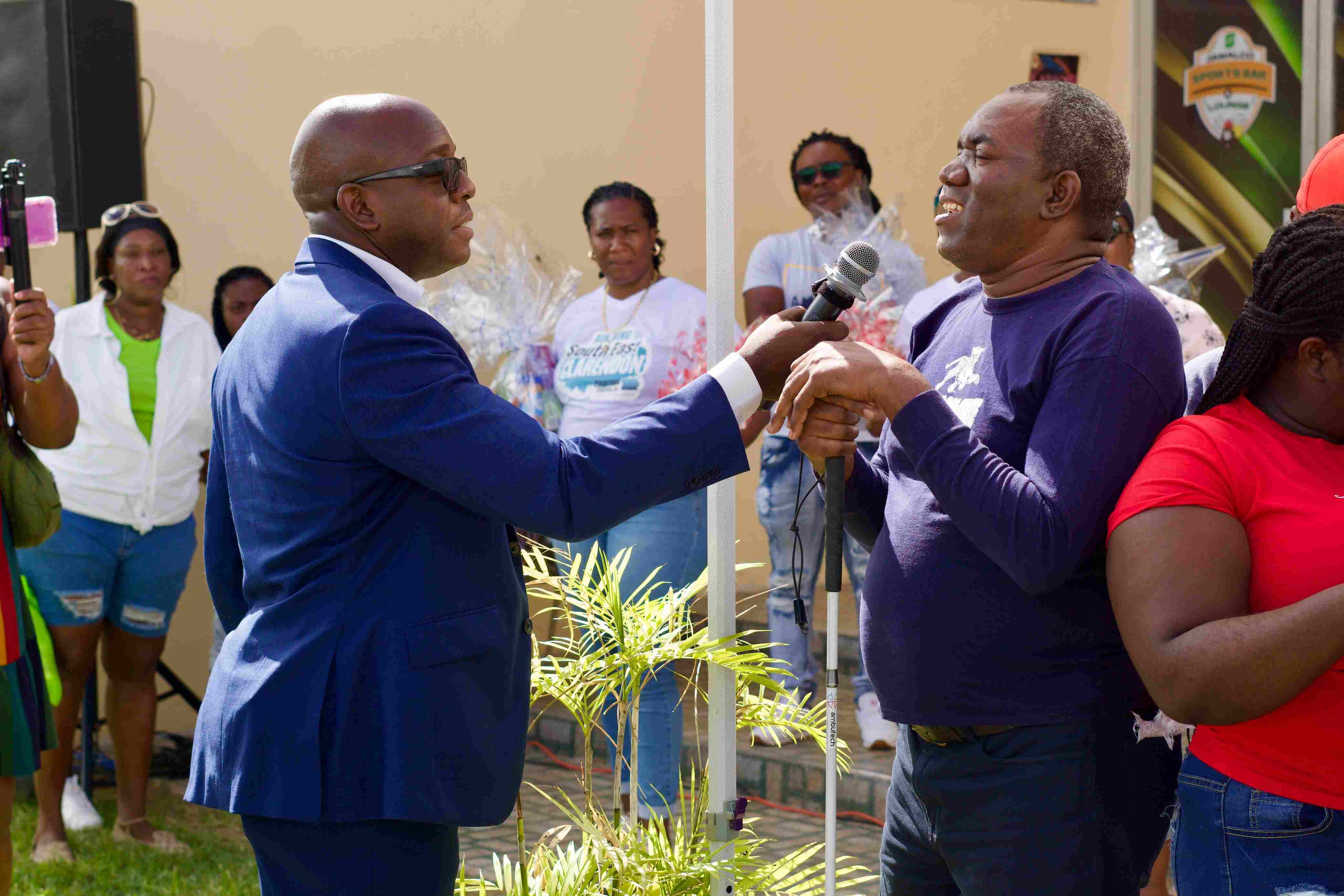 Member of Parliament for South East Clarendon Pearnel Charles engages a blind participant at the Joyful Hearts Outreach Initiative in Clarendon recently. Blind Community Steals the Spotlight at MP Pearnel Charles Jr.’s Joyful Hearts Outreach Initiative