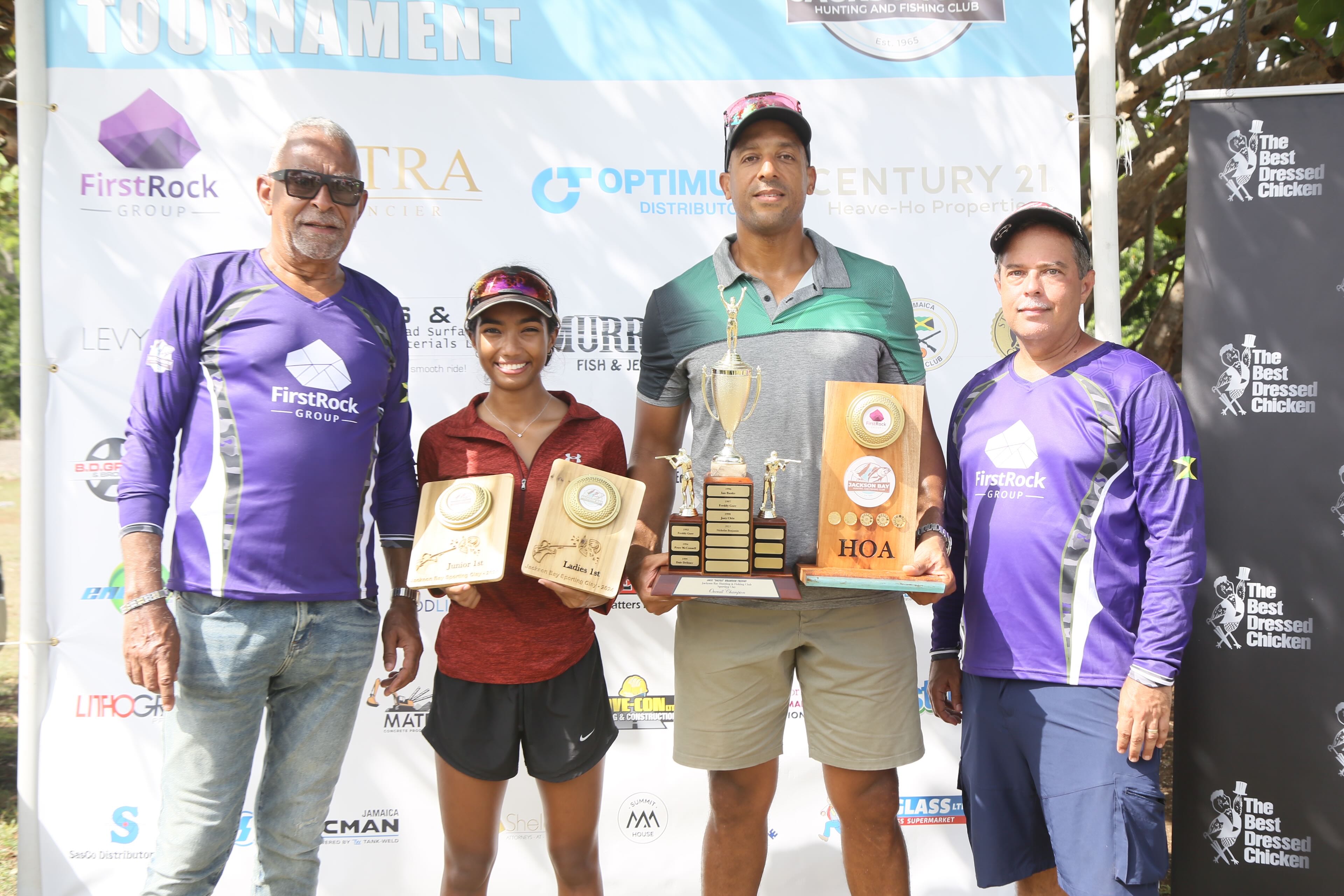 (from left) First Rock's Director Dr Michael Banbury poses for photos with the winners in this years' Jackson Bay Clay Shooting Tournament on Sunday Aliana McMaster and Craig Simpson while Sean Clacken Head of the Gun Club looks on in Clarendon on Sunday. Craig Simpson dethrones Benjamin to take top spot at Jackson Bay Sporting Clays, Aliana McMaster continues her winning streak