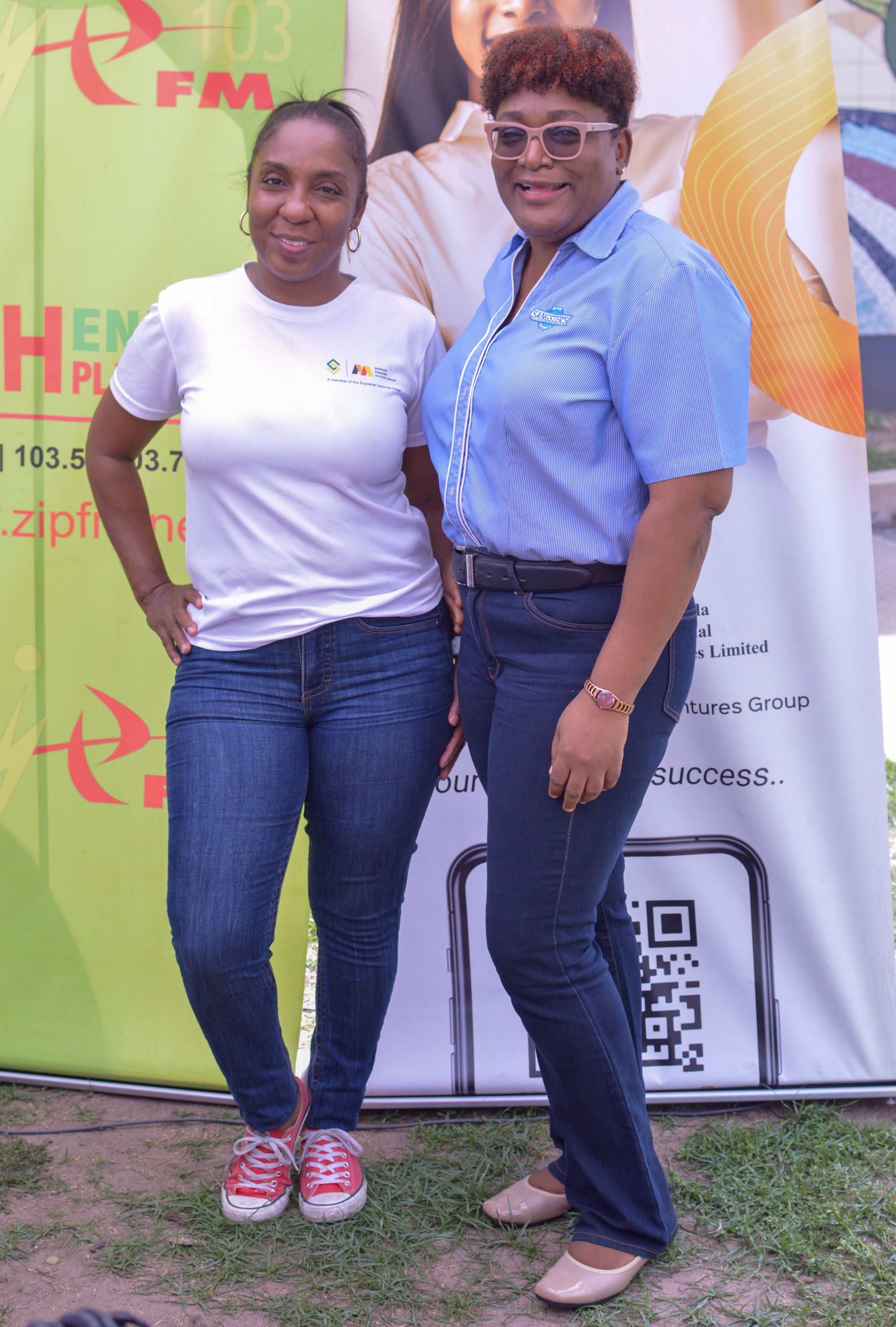 McKayla Financial Sales and Marketing Manager Pauline Shuttleworth (left) pauses their give back activities to take a quick photo with Business Development Officer (right) Nanisha Lee during the back to school launch event at Sangster's Bookstore in the Springs Plaza on Saturday. McKayla shares early back to school assistance