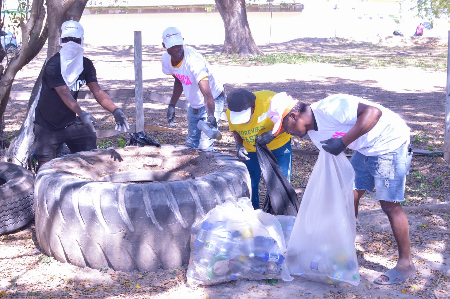 Devon Brown, Devin Biggs Michael Anderson and Jermaine Beckford remove debris and garbage from the grounds of Caymanas Park during last years' Recycling Initative Caymanas Park to host Recycling Initiative in Portmore