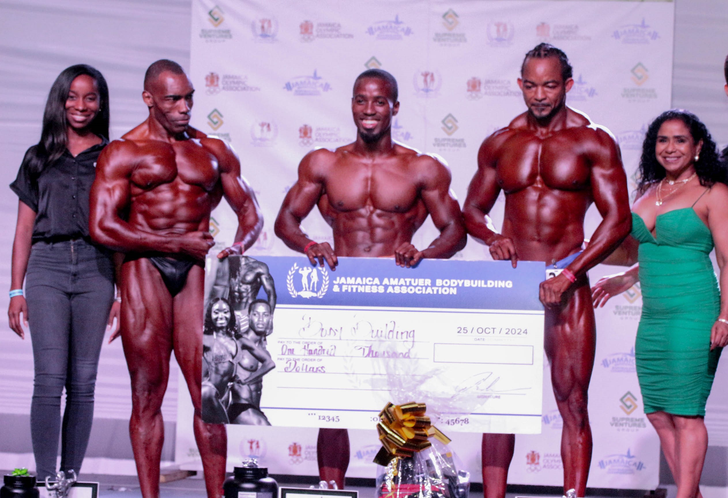 Supreme Ventures Limited (SVL) Events and Sponsorship Officer Gabrielle Waite with the top 3 winners in the Bodybuilding Open category: 3rd place Andrew Chisholm, 1st place Nicolas Wilson, 2nd place Henry Graham and Jamaica Amateur Bodybuilding and Fitness Association (JAABFA) President Audrey Allwood at the inaugural Supreme Ventures Jamaica InvitationalBodybuilding Championships at the Courtleigh Auditorium on Saturday. Supreme Ventures Hosts Inaugural Jamaica Invitational Bodybuilding Championships
