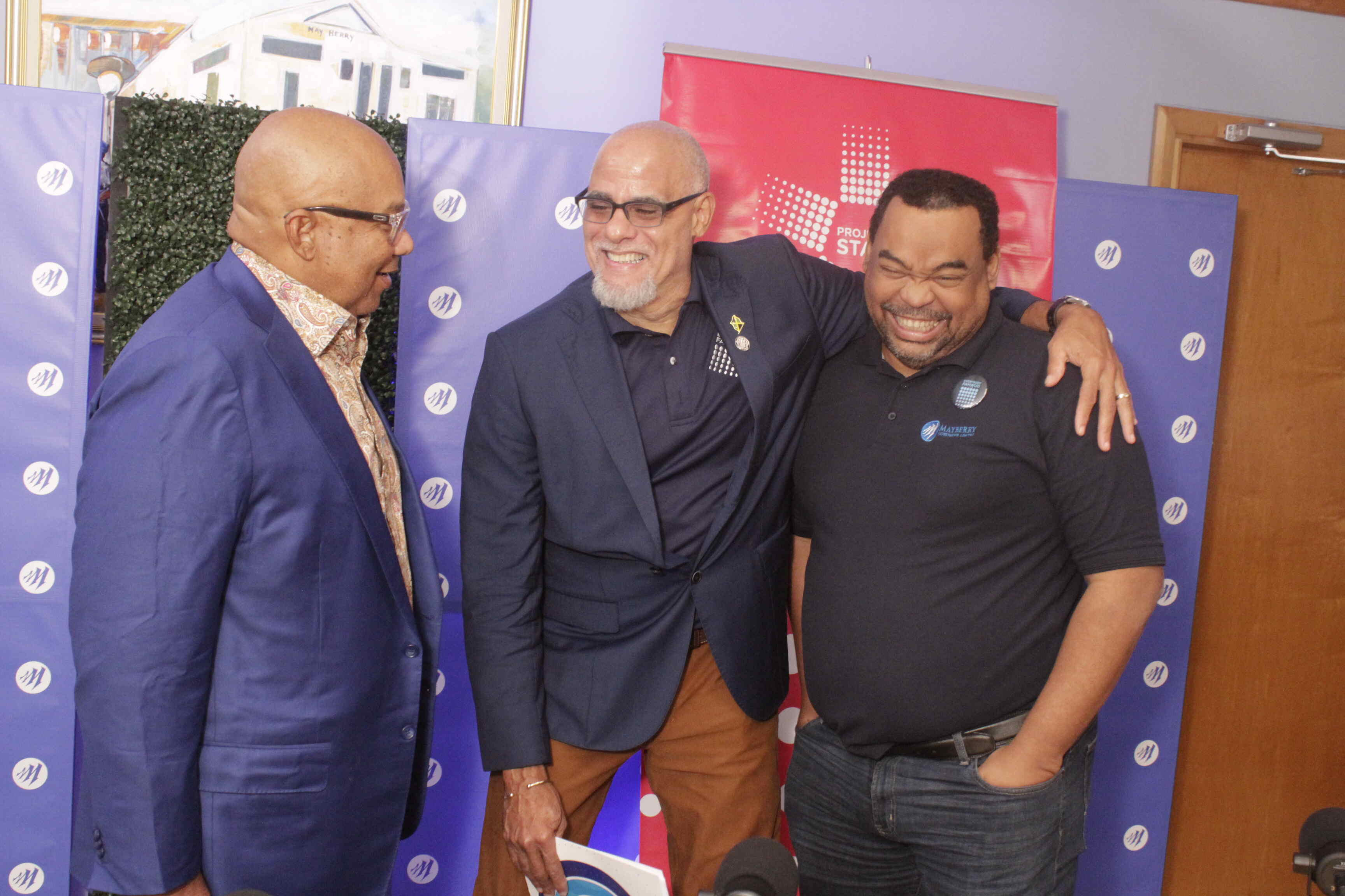 Mayberry Investments Limited CEO, Gary Peart (right), and Co-Chairman of Project Star Keith Duncan (centre) share a light moment while Executive Chairman of Mayberry Investments, Christopher Berry (left) looks on. Mayberry Investments and Project STAR: A Continuing Partnership for Community Transformation
