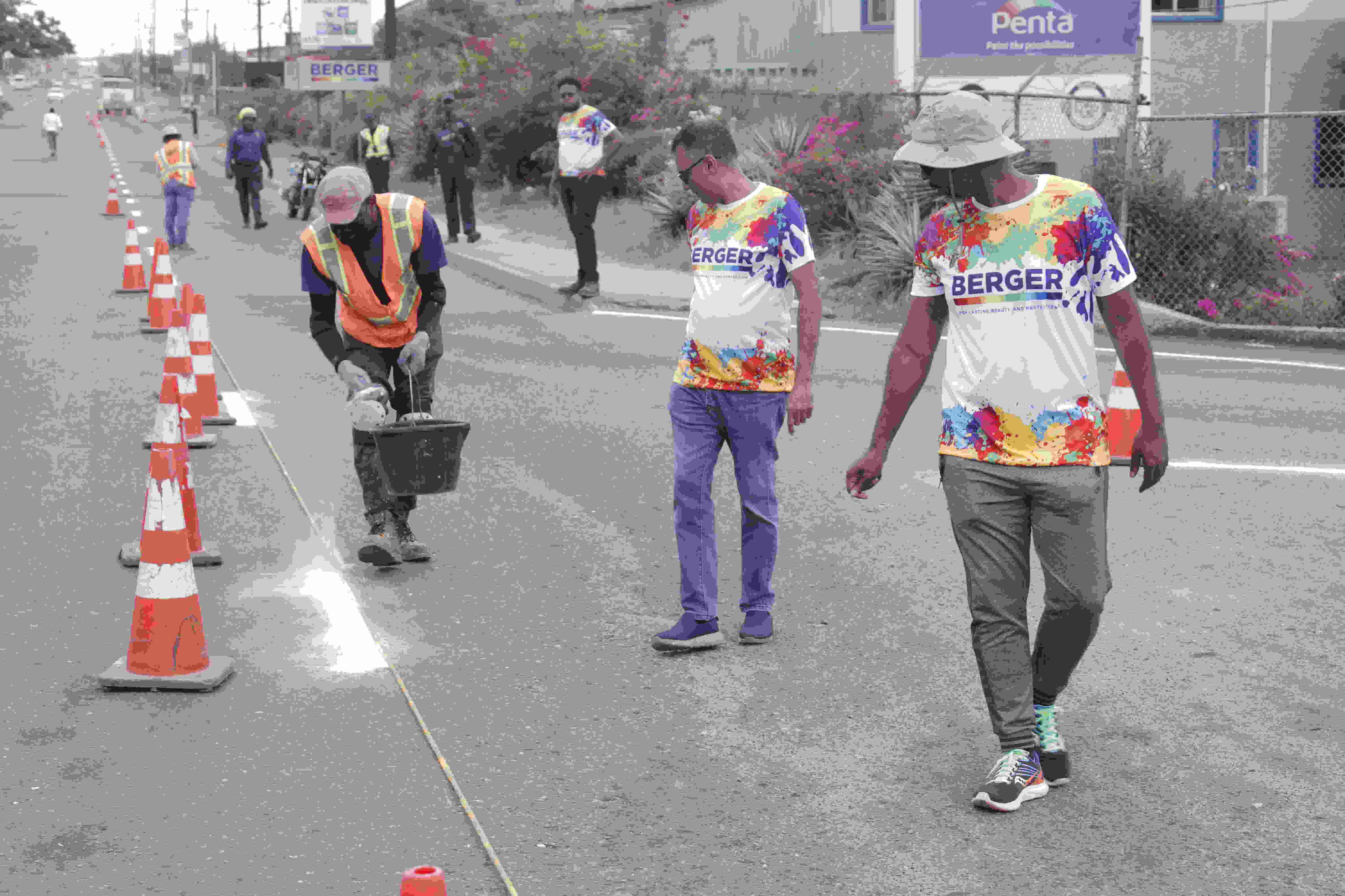 Berger Paints Jamaica Ltd. Coatings Sector Operations Manager, Allan Ramlal, and General Manager, Dwaine Williams oversee the work being done as Project Reflect and Protect commences. JCC, Berger Paints Jamaica Ltd. And The NWA Partner to Pilot Project “Reflect and Protect’ In Support Of The Effort To Enhance Road Safety