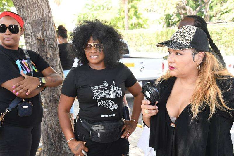 Singer Tanya Stephens (centre) and media personality Carlene "Dancehall Queen" Smith (right)join in the demonstration at Emancipation Park on Tuesday.