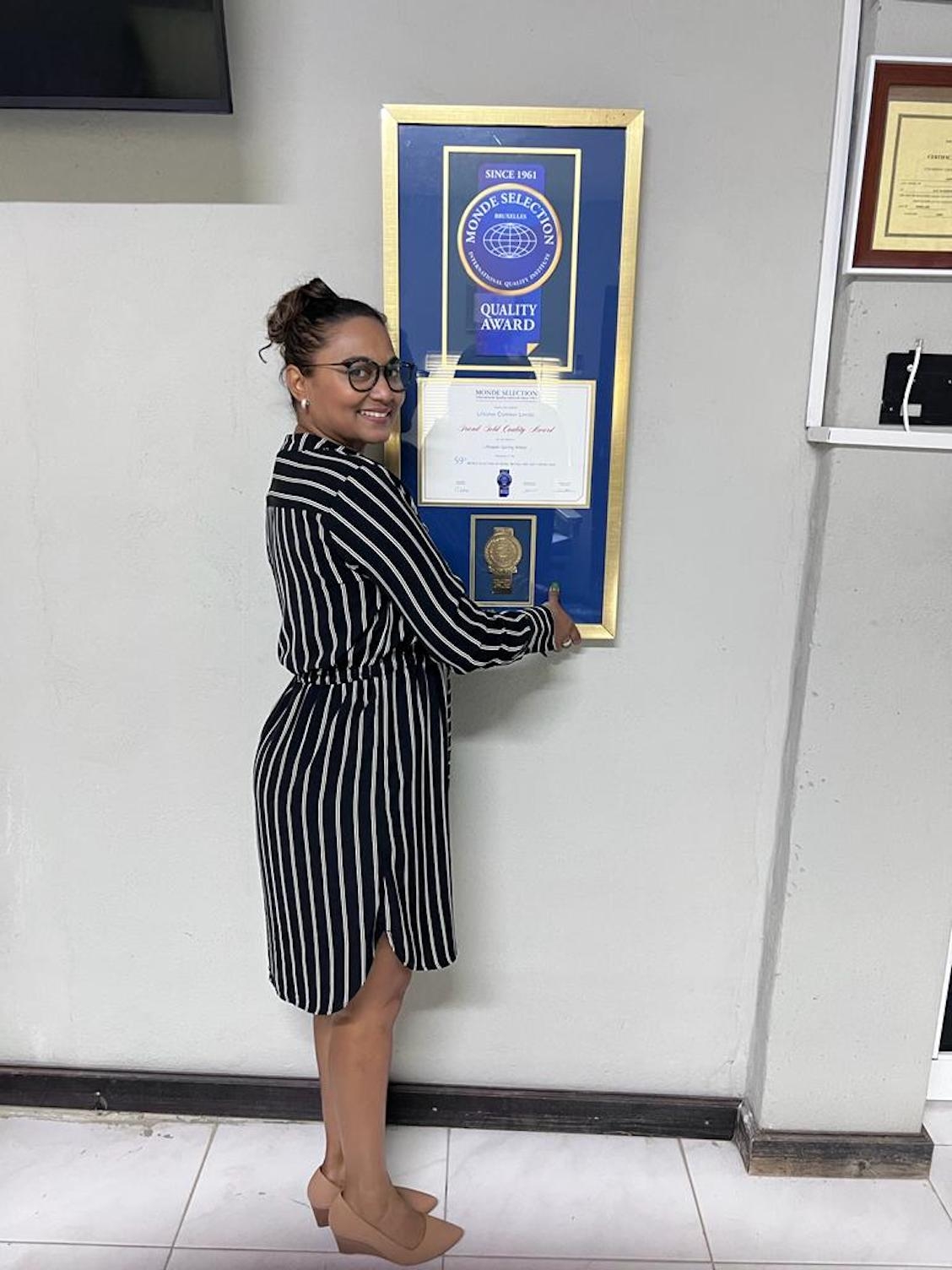 Lifespan CEO Nayana Williams proudly displays Monde award